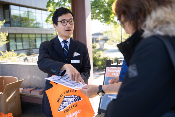 Shusaku helping student at event