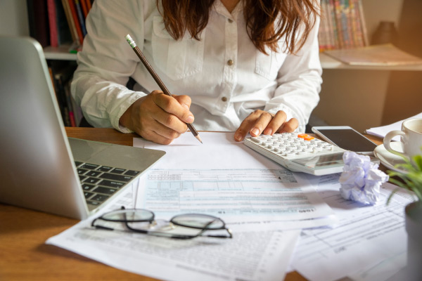 Agent at desk with laptop and tax documents